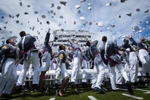 West Point cadets throwing their caps in the air after their graduation ceremony.