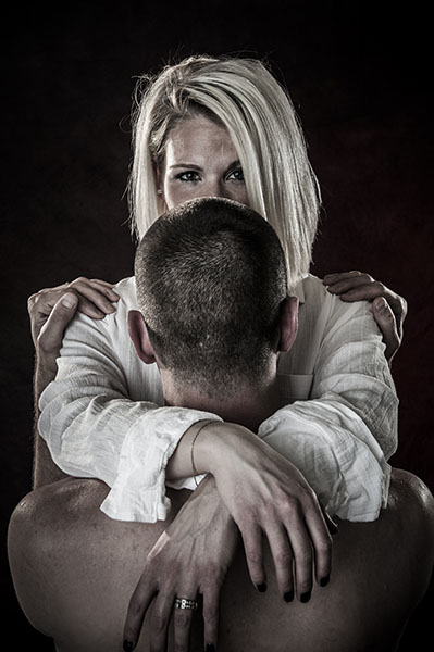 Blond woman looking over head of husband