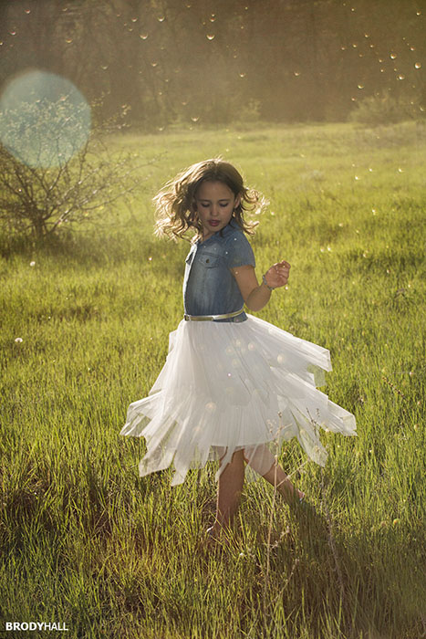 Girl dancing in field at Lair of the Bear park in Morrison Co.