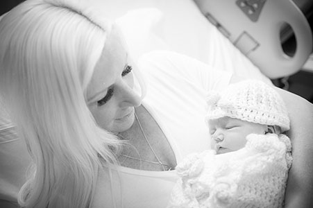 Mother holding baby in black and white
