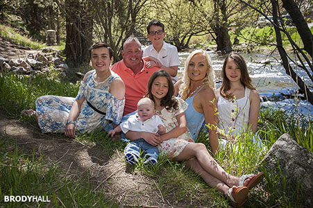 Family of seven posing for photos by stream just North of Morrison, CO