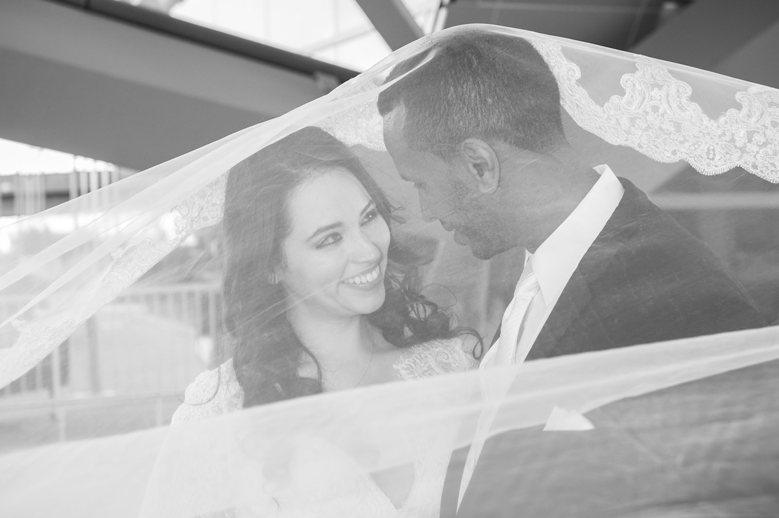 Bride and groom beneath the veil at the Westin Hotel at the Denver International Airport