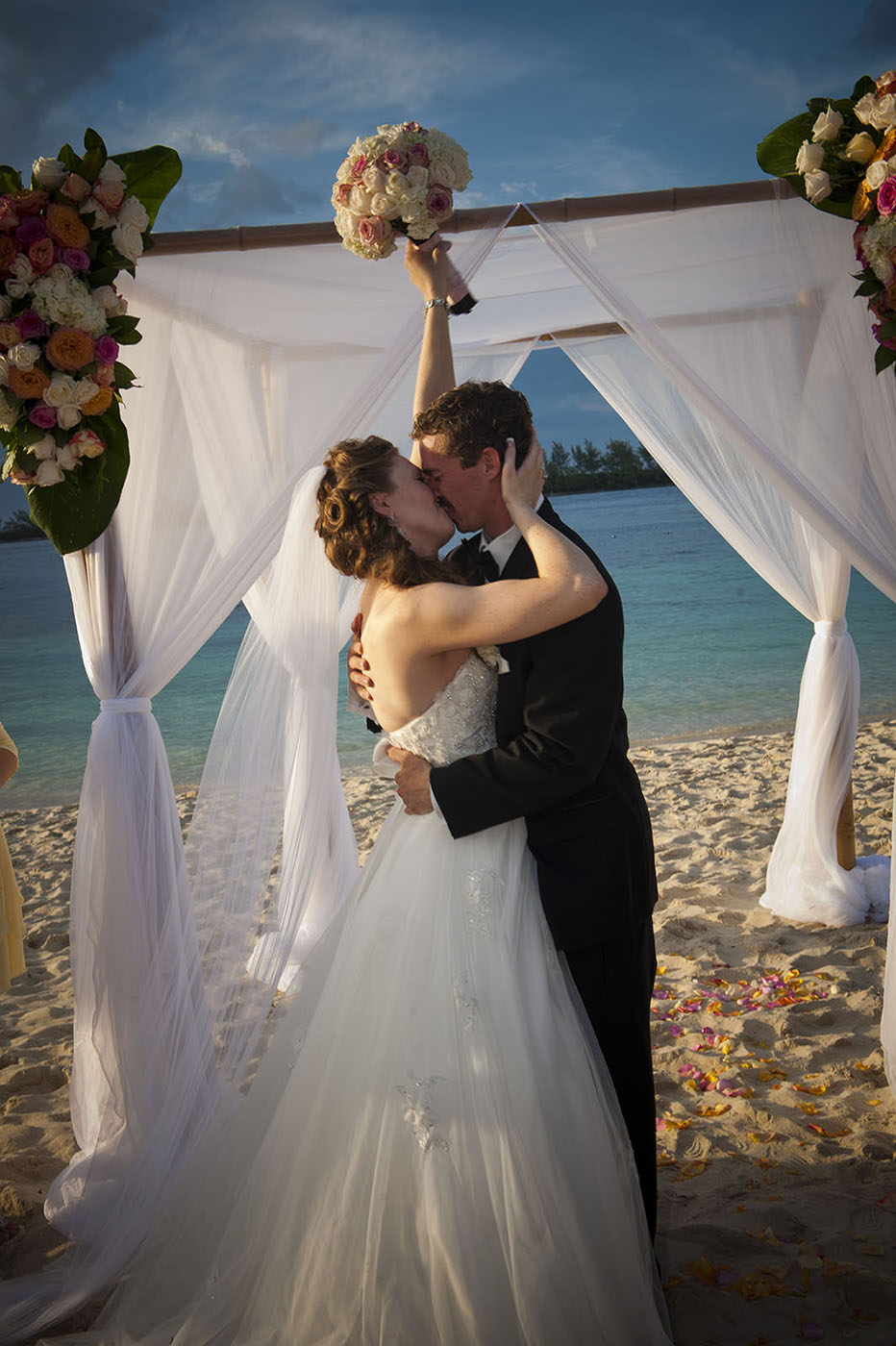 Bridal couple kissing on beach in the Bahamas