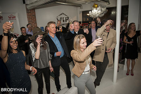 Guest raising glasses at a VIP Real Estate company party