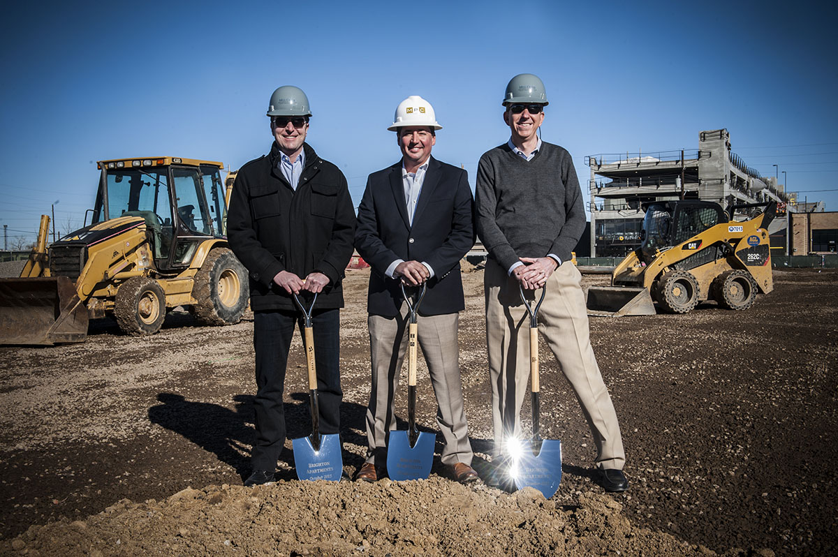 Three employees of MPC construction with shovels during a ground breaking ceremony.