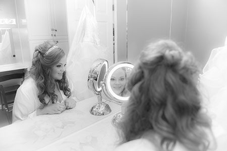 Bride getting ready looking in mirror