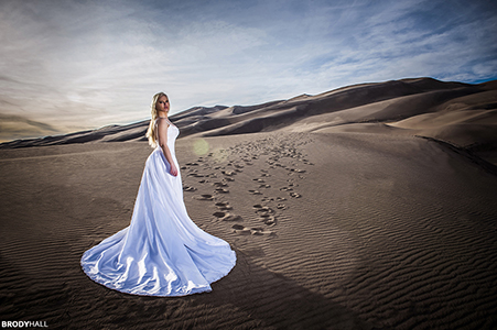 Sky in bridal dress standing in the Sand Dunes