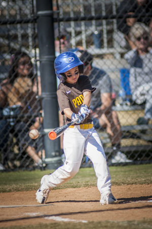 Little league baseball player swinging their bat