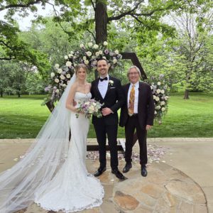 Wedding Officiant Norm McDonald standing with bride and groom.
