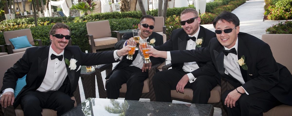 Groom and groom's men toasting at a wedding in the Bahamas.