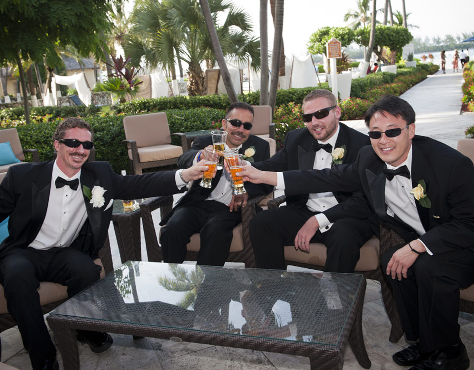 Groom and groom's men toasting at a wedding in the Bahamas.
