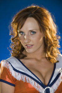Professional Colorado Cheerleader headshot photographed in Denver practice gym.
