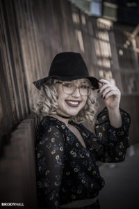 beautiful senior girl standing on Colorado bridge