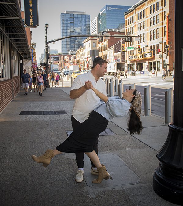 Yitzy dipping his wife, Leah, on a Broadyway sidewalk.