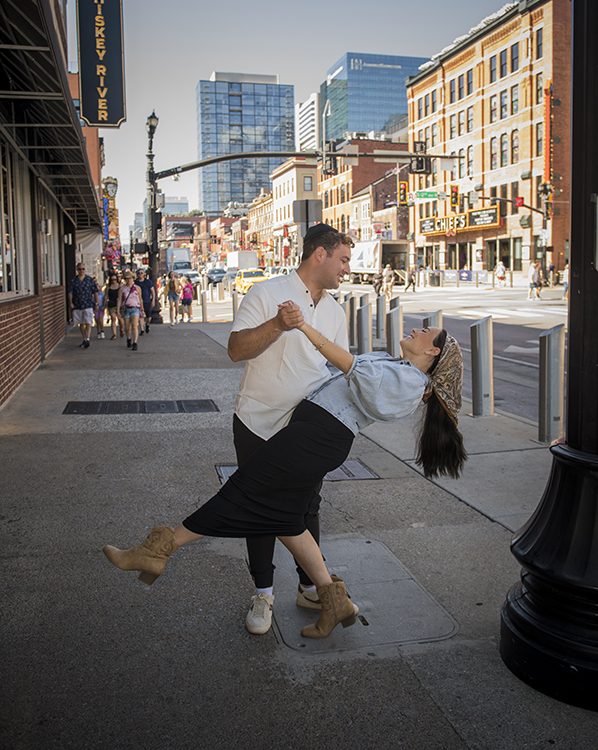 Yitzy dipping his wife, Leah, on a Broadyway sidewalk.